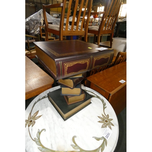 A novelty occasional wine table built as if a pile of books