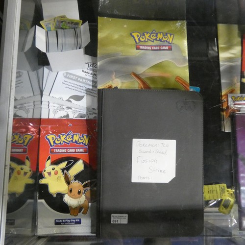 691 - A quantity of various Pokémon collectible items inc Trading cards, posters, ultimate guard folder wi... 