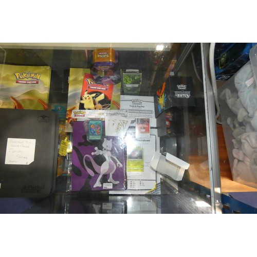 692 - A quantity of various Pokémon collectible items inc Trading cards, posters, Mew 2 folder, 3 deck cas... 