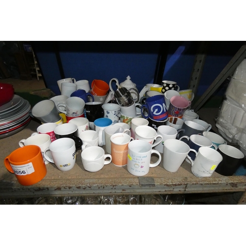 2056 - A quantity of various size mugs and a teapot. Contents of 1/2 a shelf