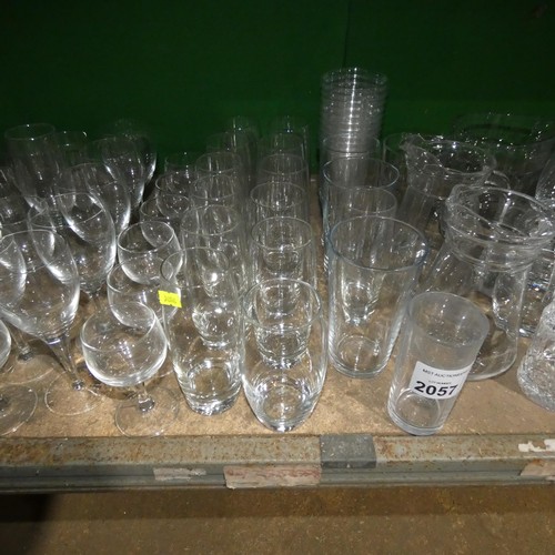 2057 - A quantity of various drinking glasses, water jugs etc. Contents of 1 shelf