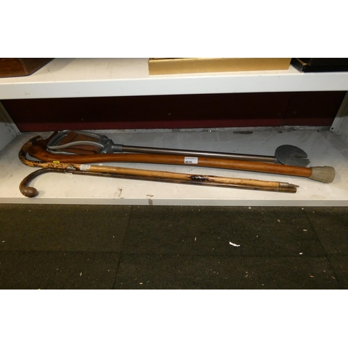 4010 - A vintage shooting stick and 3 decorative walking sticks (1 shelf)