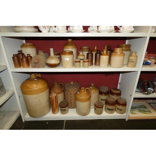 4023 - A large stoneware jar and a large quantity of other smaller stoneware jars, bottles and hot water bo... 