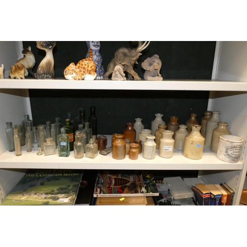 4057 - A quantity of small stoneware bottles and vintage glass bottles (one shelf)