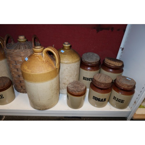 4023 - A large stoneware jar and a large quantity of other smaller stoneware jars, bottles and hot water bo... 