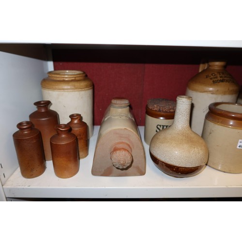 4023 - A large stoneware jar and a large quantity of other smaller stoneware jars, bottles and hot water bo... 