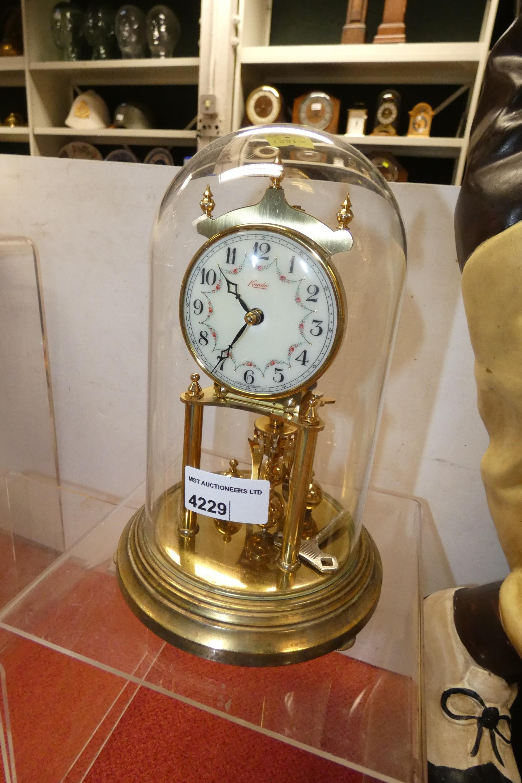A brass 400 day clock under a glass dome