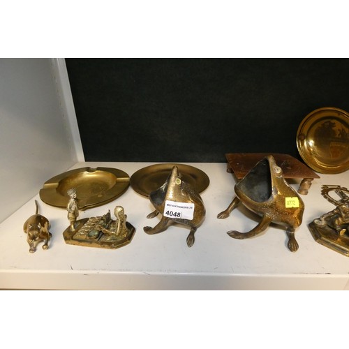 4048 - A large brass kettle, various large brass trays and a quantity of miscellaneous decorative brass war... 