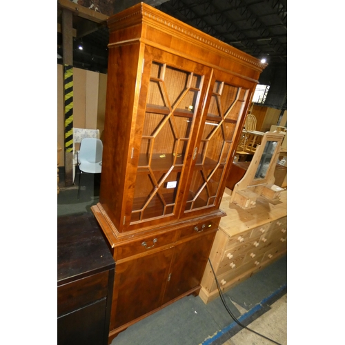 3125 - A reproduction two piece cabinet with two glass doors above and two drawers / two doors below, appro... 