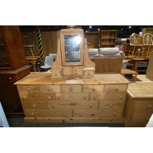 3126 - A pine chest of 13 drawers approx 170cm wide and a pine table top dressing mirror