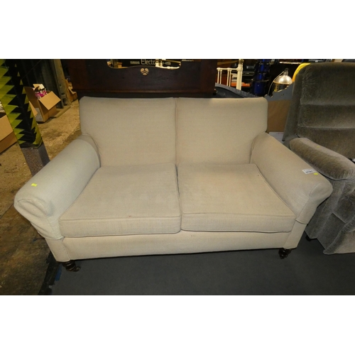 3141 - A light upholstered sofa on turned wooden legs, approx 150cm wide