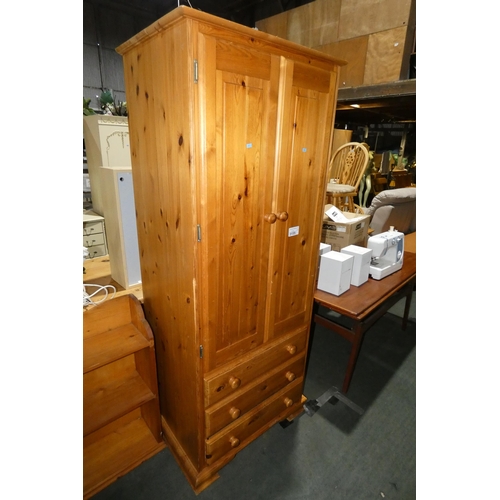 3155 - A pine wardrobe with 2 doors and 3 drawers below approx 77cm w x 56cm d x 189cm high