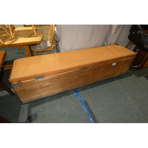 3158 - A wooden storage box on wheels with hinged lift up lid approx 183 x 45 x 50cm high