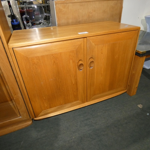 3207 - An Ercol cabinet with two wooden doors approx 91 cm wide / 70cm high /