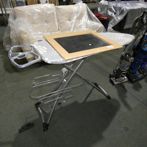 3214 - A folding ironing board and a framed mirror approx 63 x 53cm