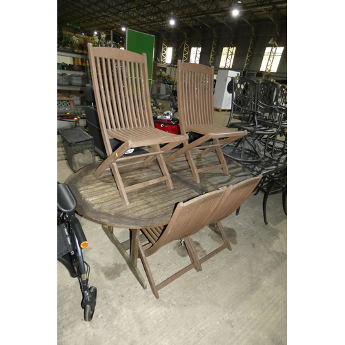 3056 - An oval wooden garden dining table approx 180 x 100cm and 4 x folding wooden chairs