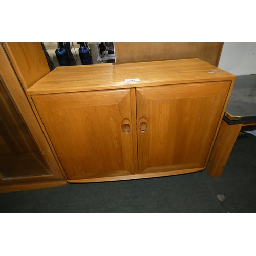 3207 - An Ercol cabinet with two wooden doors approx 91 cm wide / 70cm high /