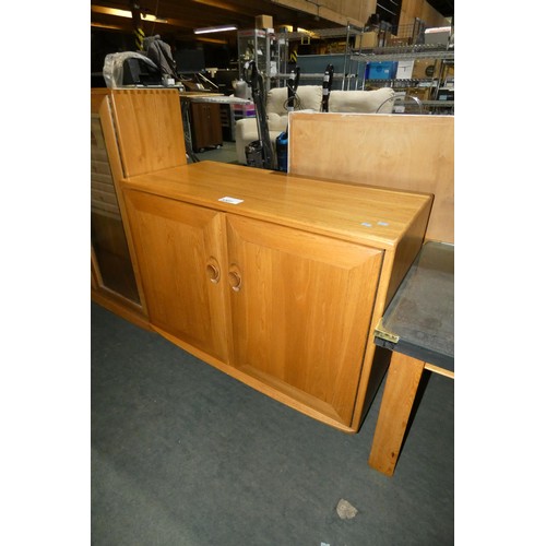 3207 - An Ercol cabinet with two wooden doors approx 91 cm wide / 70cm high /