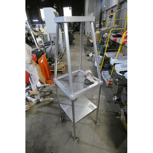 5040 - A small metal table on wheels with a frame attached above