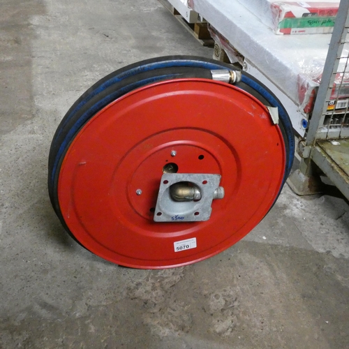 5070 - A fire hose on a red metal reel