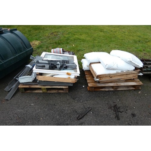 6124 - 2 pallets containing several bags of pea gravel, a window and various other related items