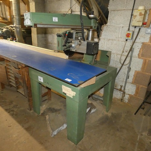 39 - A Maggi cross cut radial arm saw 3ph. This is a free standing saw that sits under the end of the tab... 