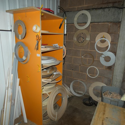 77 - A quantity of various rolls of edge banding material (the orange storage rack is also included)