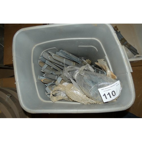 110 - A grey plastic bin containing a quantity of metal support brackets for Belfast type sinks