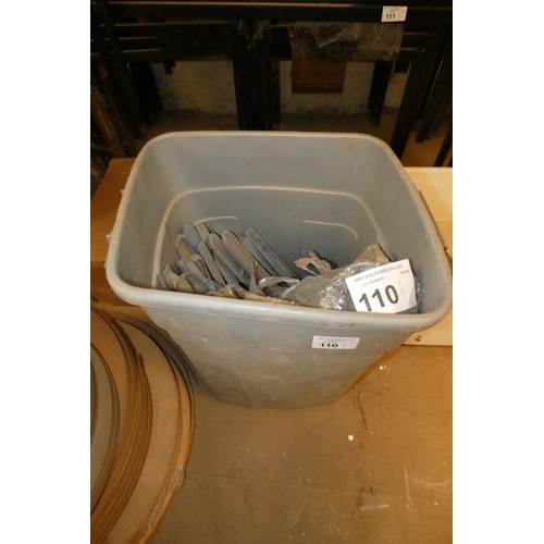 110 - A grey plastic bin containing a quantity of metal support brackets for Belfast type sinks