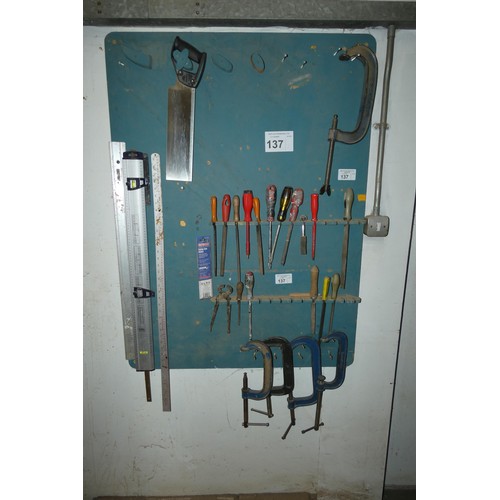 137 - A quantity of various hand tools and 5 x G clamps. Contents of a wallboard and not practical to list... 