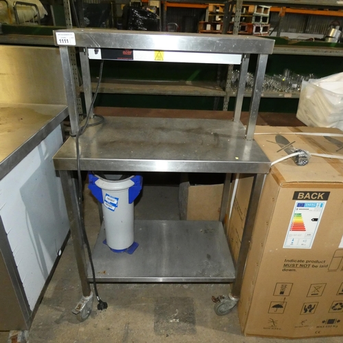 1111 - A mobile commercial stainless steel catering type table with shelf beneath and heated gantry above a... 