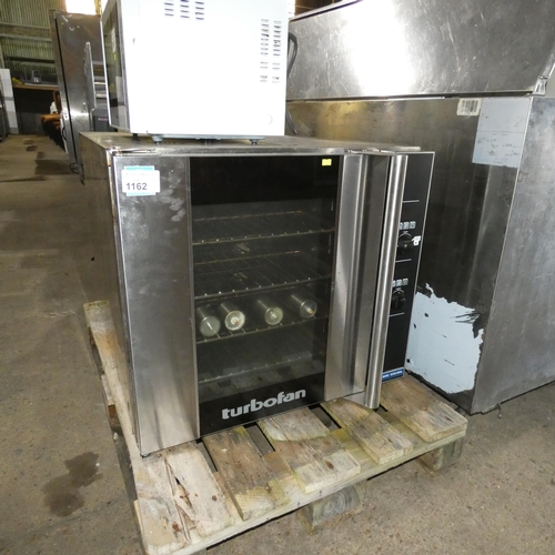 1162 - A commercial stainless steel counter top turbo fan oven by Blue Seal, legs inside, model E32D4. 240V... 