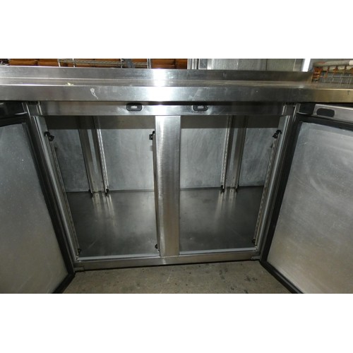 1118 - A large commercial stainless steel 4 door bench fridge by Foster type Supra approx 233x77cm - trade