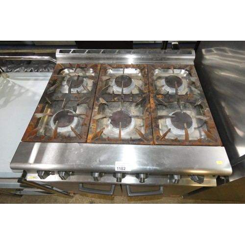 1182 - A commercial stainless steel gas fired 6 ring range with 2 door oven beneath by Falcon - trade