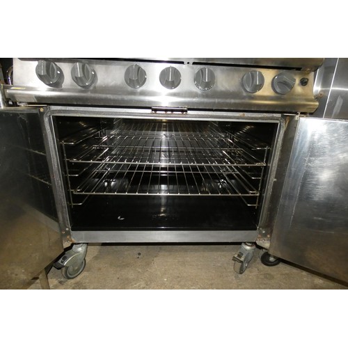 1182 - A commercial stainless steel gas fired 6 ring range with 2 door oven beneath by Falcon - trade