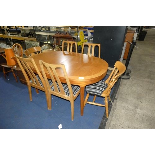 A 1990s vintage lightwood oval extending dining table with a set of