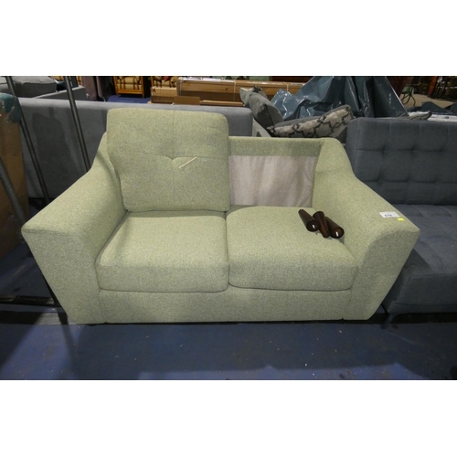 610 - A light green upholstered two person sofa. Please note that this sofa is missing one of the back cus... 