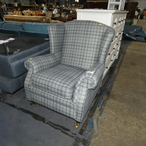 613 - A grey check upholstered wing back arm chair