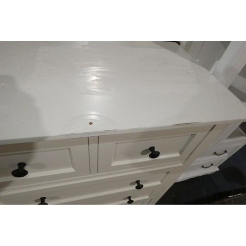 614 - A white chest of 8 drawers approx 153cm wide. Please note that this chest of drawers has a damage to... 