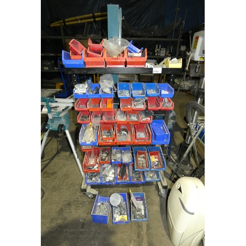 6782 - A wheeled frame containing a quantity of various hanging plastic stores type boxes and contents whic... 