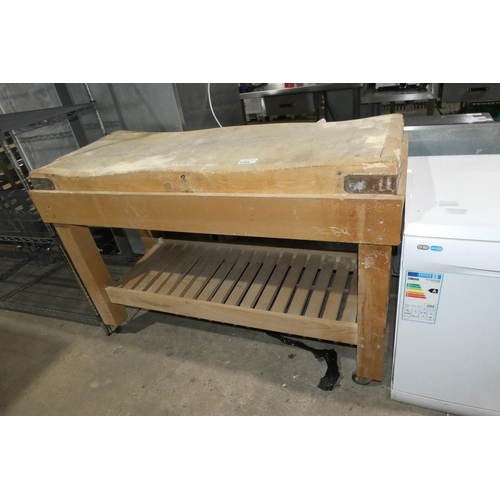 1151 - A large commercial wooden chopping board on a wooden stand approx 156x65x106. Please note this will ... 