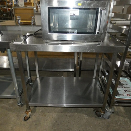 1193 - A commercial stainless steel catering type mobile table with shelf beneath approx 90x60cm