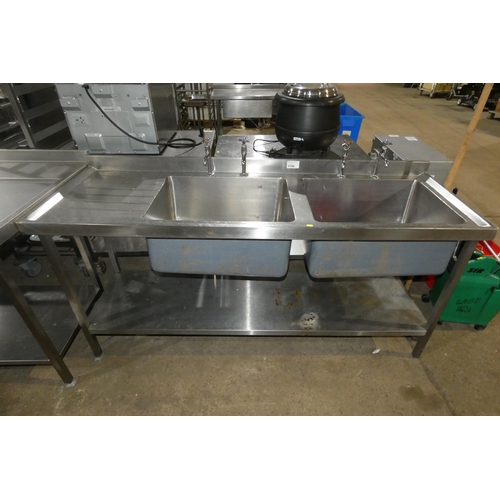 1198 - A commercial stainless steel twin deep sink unit with draining board to the left and shelf beneath a... 