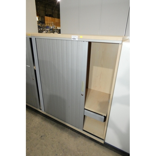 1262 - A metal and wood effect office cabinet with a single tambour door approx 100x50x120cm