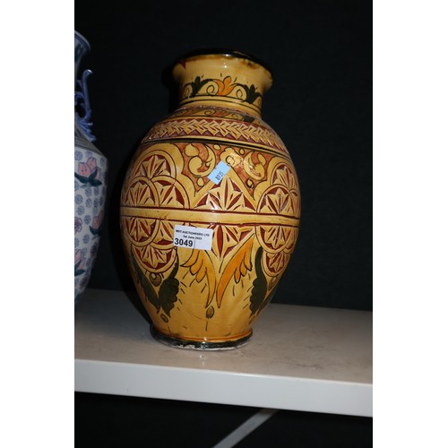 3049 - A pair of blue and white oriental style decorated vases and a yellow decorative pottery vase