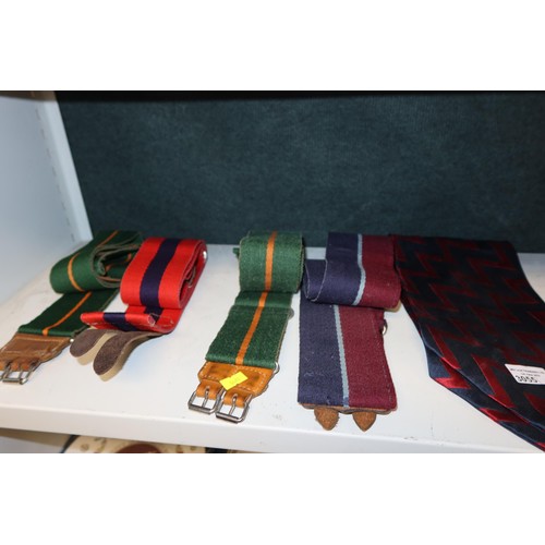 3055 - A military cap, four military belts and a blue and red crevat (one shelf)