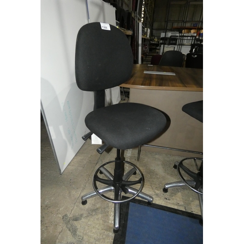 1388 - A tall black upholstered operators stool