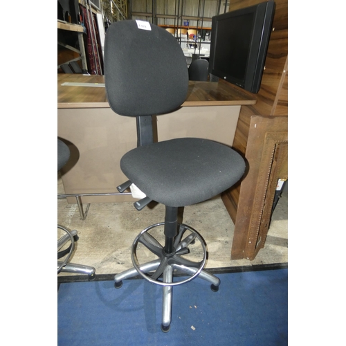 1389 - A tall black upholstered operators stool