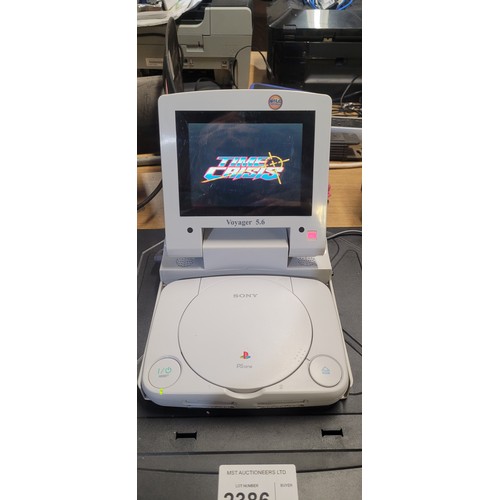 2386 - A Sony Playstation 1 console with voyager 5.6 in car portable screen, a quantity of top rated games ... 