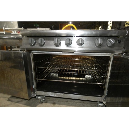 1176 - A gas fired commercial stainless steel 6 burner range with 2 door oven beneath by Falcon - trade